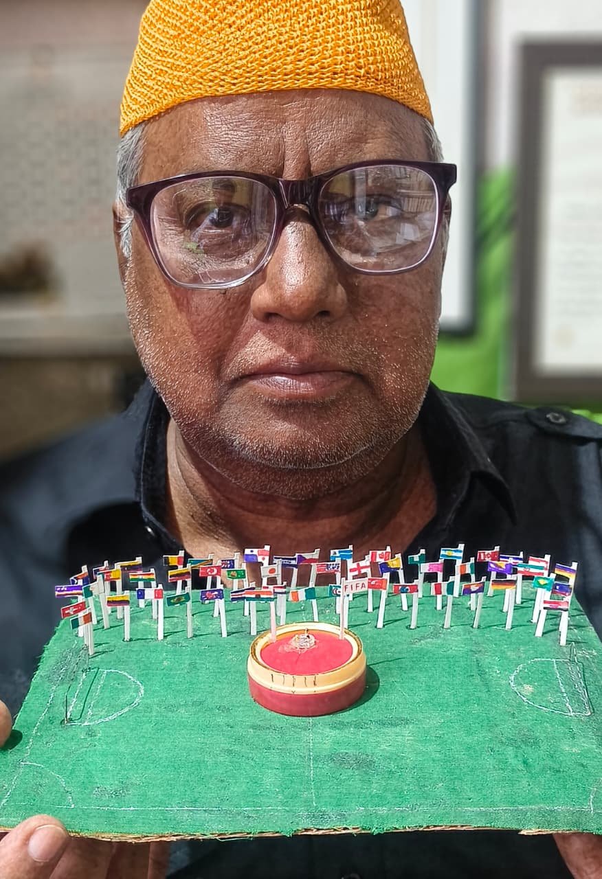###Dr. Iqbal Sakka Artistically Expresses the Absence of India's Tricolour at the FIFA World Cup with a Unique 50-Flag Installation